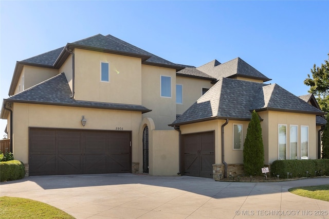 5905 W Charleston St, Broken Arrow, OK 74011 - view of front of property featuring driveway, stone siding, stucco siding, and a shingled roof