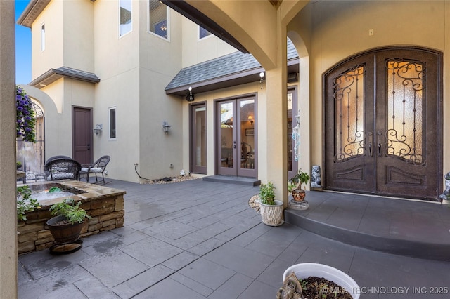 5905 W Charleston St, Broken Arrow, OK 74011 - property entrance featuring a patio area, french doors, and stucco siding