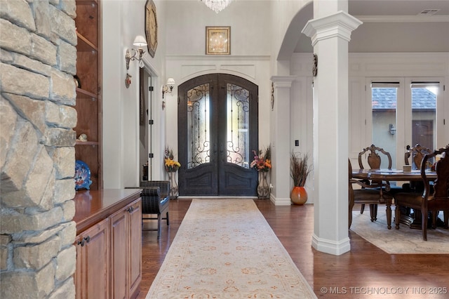 5905 W Charleston St, Broken Arrow, OK 74011 - foyer featuring dark wood-style floors, visible vents, french doors, arched walkways, and decorative columns