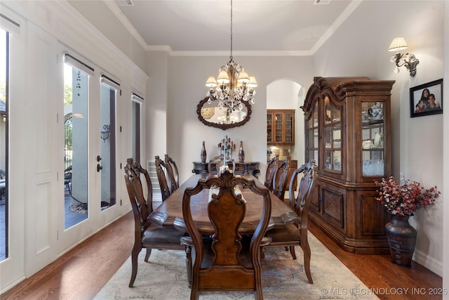 5905 W Charleston St, Broken Arrow, OK 74011 - dining area with baseboards, wood finished floors, an inviting chandelier, and ornamental molding