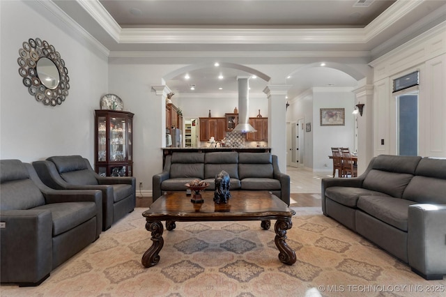 5905 W Charleston St, Broken Arrow, OK 74011 - living area with baseboards, arched walkways, ornamental molding, and decorative columns