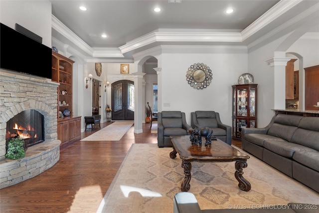 5905 W Charleston St, Broken Arrow, OK 74011 - living area featuring crown molding, wood finished floors, arched walkways, a raised ceiling, and ornate columns