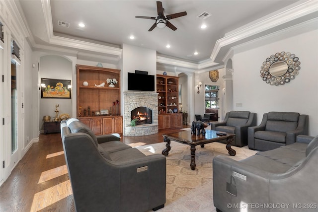 5905 W Charleston St, Broken Arrow, OK 74011 - living area with wood finished floors, a ceiling fan, visible vents, and a stone fireplace