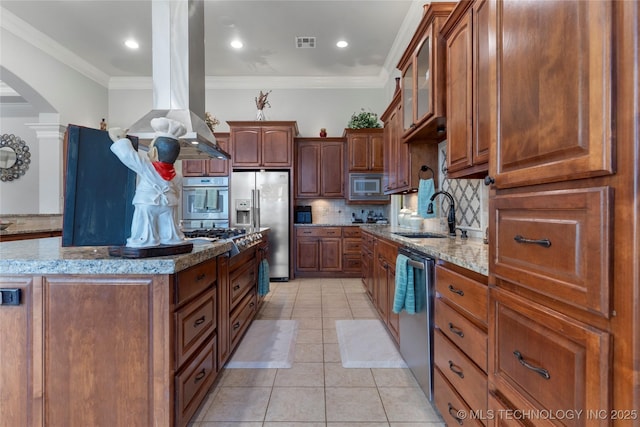 5905 W Charleston St, Broken Arrow, OK 74011 - kitchen with a sink, island range hood, arched walkways, stainless steel appliances, and visible vents