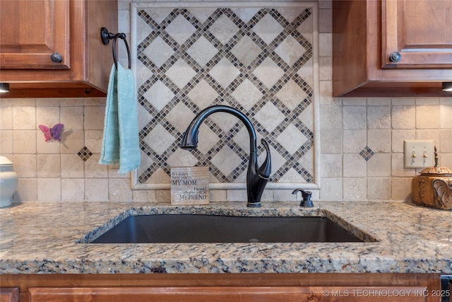 5905 W Charleston St, Broken Arrow, OK 74011 - interior details featuring brown cabinets, light stone countertops, and a sink