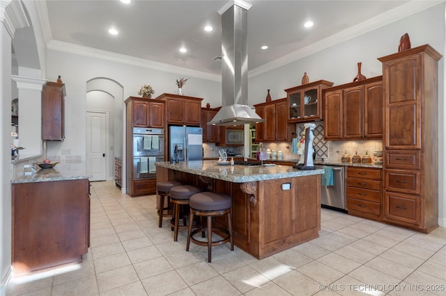 5905 W Charleston St, Broken Arrow, OK 74011 - kitchen with island exhaust hood, backsplash, stainless steel appliances, and light tile patterned floors