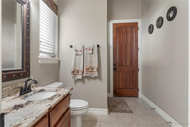 5905 W Charleston St, Broken Arrow, OK 74011 - bathroom with vanity, toilet, tile patterned flooring, and baseboards