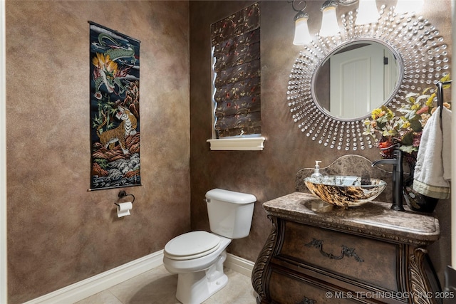 5905 W Charleston St, Broken Arrow, OK 74011 - half bathroom with baseboards, tile patterned flooring, vanity, and toilet
