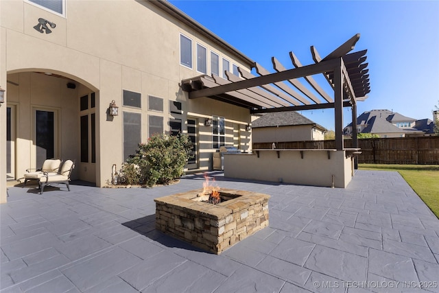 5905 W Charleston St, Broken Arrow, OK 74011 - view of patio featuring fence, a pergola, a fire pit, and an outdoor kitchen