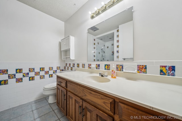 3316 S Ash Pl, Broken Arrow, OK 74012 - bathroom featuring a textured ceiling, a stall shower, vanity, tile patterned floors, and toilet