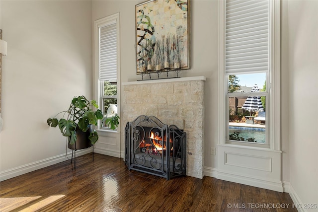 4416 S Orange Ave, Broken Arrow, OK 74011 - room details with a stone fireplace, wood finished floors, and baseboards