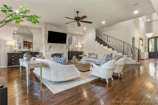 4416 S Orange Ave, Broken Arrow, OK 74011 - living area featuring baseboards, wood finished floors, ceiling fan, stairway, and a stone fireplace