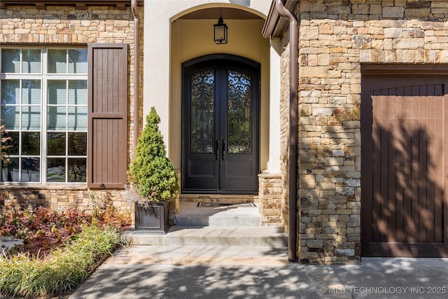 4416 S Orange Ave, Broken Arrow, OK 74011 - view of exterior entry with stone siding and french doors