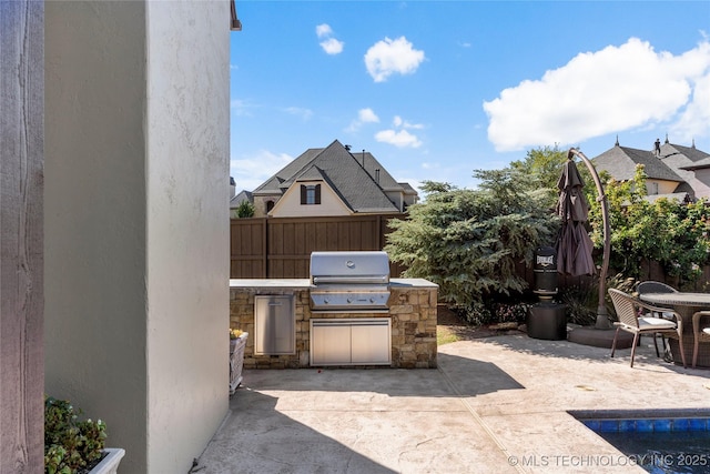 4416 S Orange Ave, Broken Arrow, OK 74011 - view of patio with a grill, fence, and exterior kitchen