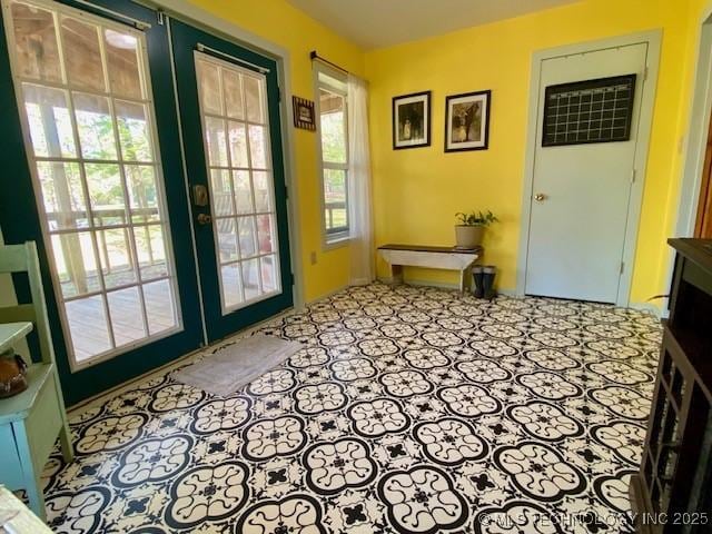 doorway with french doors and a healthy amount of sunlight