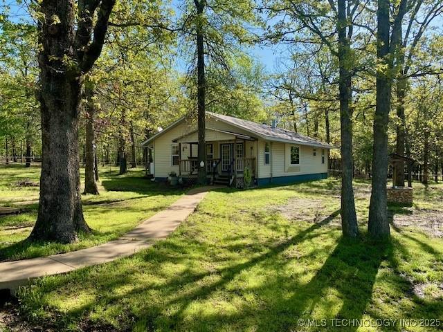view of front of house featuring a front lawn and covered porch