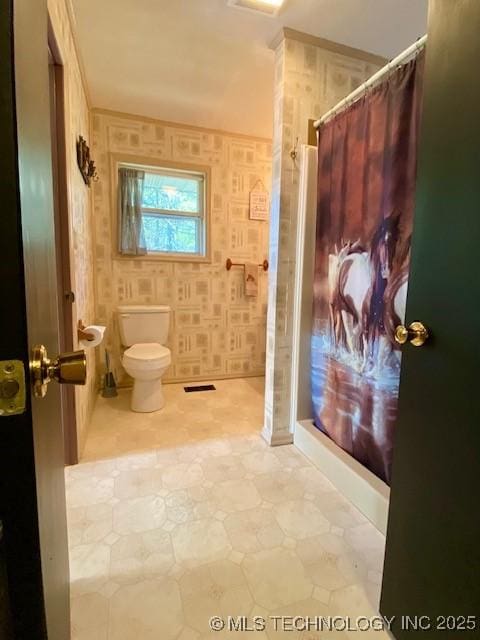 full bathroom with tile patterned floors, toilet, and curtained shower