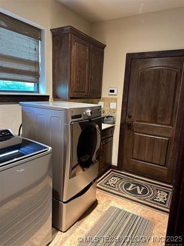 washroom with cabinet space and independent washer and dryer