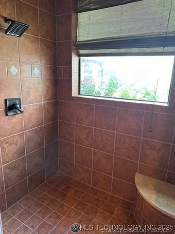 full bathroom with tiled shower