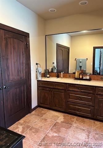 bathroom with recessed lighting and vanity