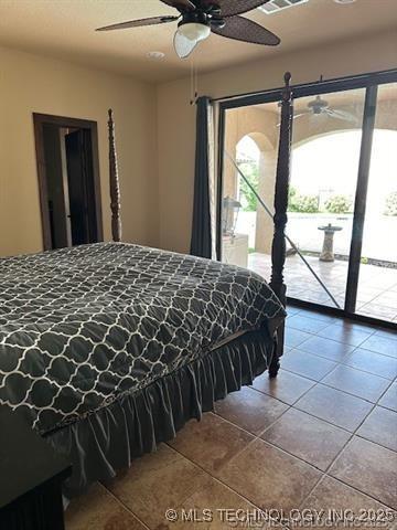 tiled bedroom featuring a ceiling fan and access to exterior