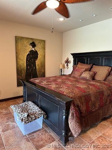 bedroom with ceiling fan and baseboards