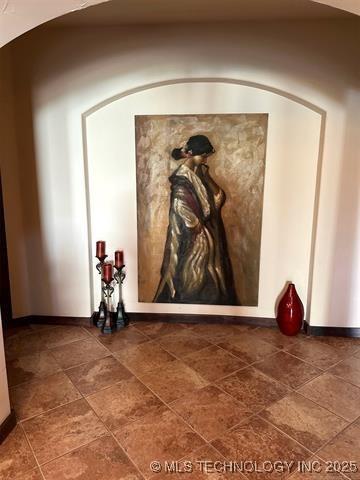interior details featuring arched walkways and baseboards