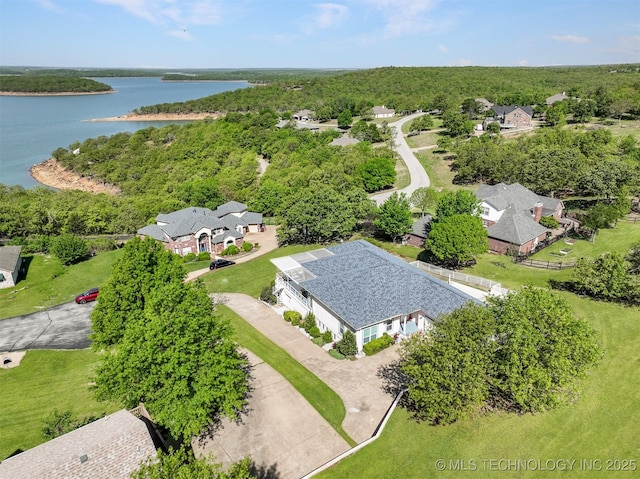 aerial view featuring a view of trees and a water view