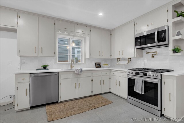 3644 S Louisville Ave, Tulsa, OK 74135 - kitchen featuring appliances with stainless steel finishes, a sink, backsplash, light countertops, and open shelves