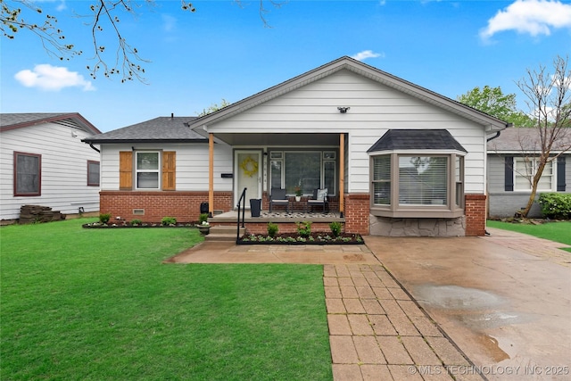 3644 S Louisville Ave, Tulsa, OK 74135 - view of front facade with brick siding, covered porch, a front lawn, and roof with shingles