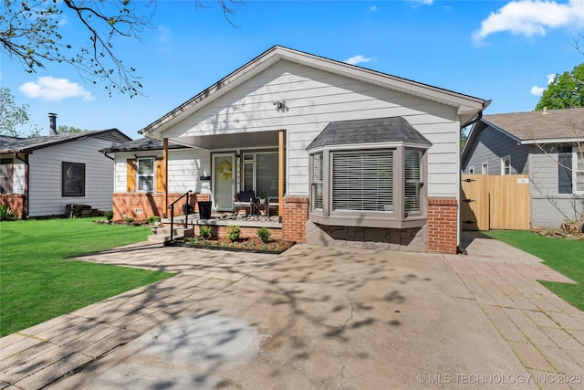 3644 S Louisville Ave, Tulsa, OK 74135 - back of house with covered porch and brick siding