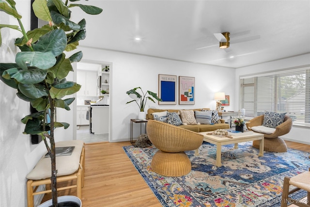 living room with recessed lighting, light wood-style floors, a ceiling fan, and baseboards