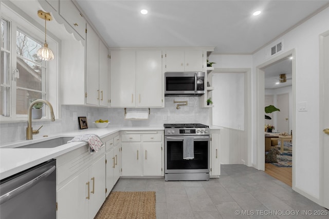 3644 S Louisville Ave, Tulsa, OK 74135 - kitchen featuring appliances with stainless steel finishes, light countertops, tasteful backsplash, a sink, and white cabinets