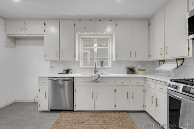 3644 S Louisville Ave, Tulsa, OK 74135 - kitchen with appliances with stainless steel finishes, tasteful backsplash, a sink, and light countertops
