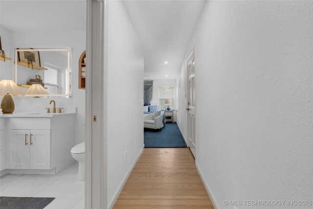 3644 S Louisville Ave, Tulsa, OK 74135 - hallway featuring a sink, recessed lighting, and baseboards