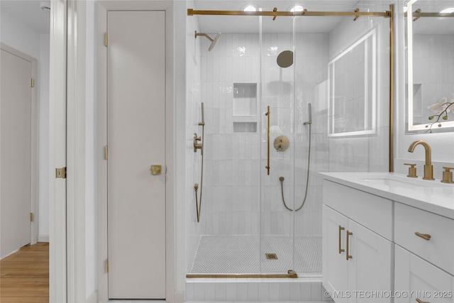 3644 S Louisville Ave, Tulsa, OK 74135 - full bathroom featuring a stall shower, vanity, and wood finished floors