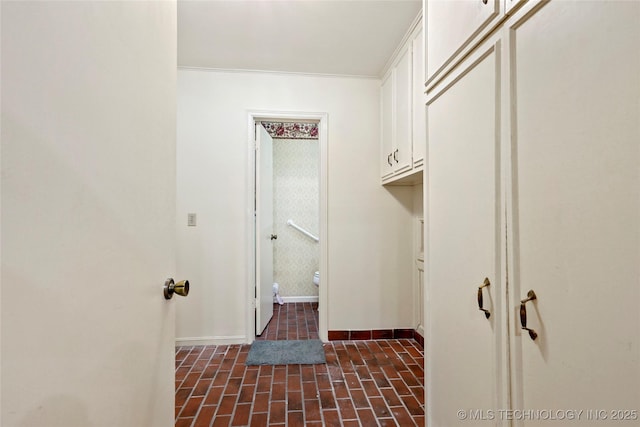 6020 S Marion Pl, Tulsa, OK 74135 - laundry room with baseboards and brick floor