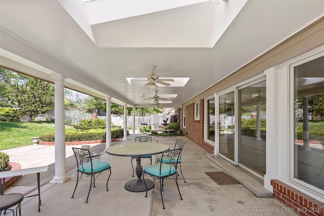 6020 S Marion Pl, Tulsa, OK 74135 - sunroom / solarium featuring concrete floors, outdoor dining space, a skylight, and a ceiling fan
