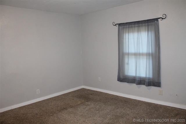 spare room with baseboards and carpet flooring