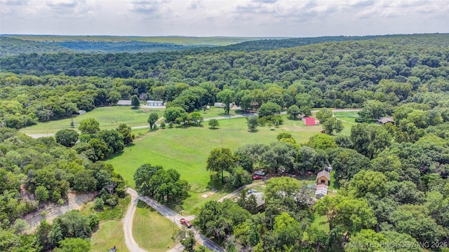 birds eye view of property with a view of trees