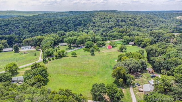 birds eye view of property featuring a wooded view