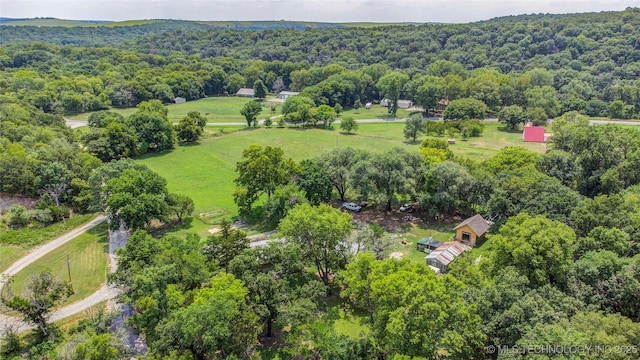 drone / aerial view with a wooded view