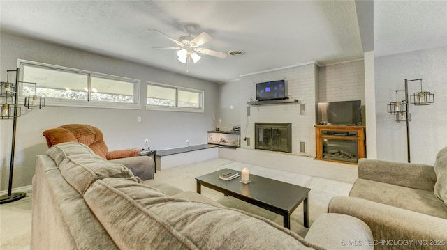 carpeted living area with baseboards, a fireplace, and ceiling fan