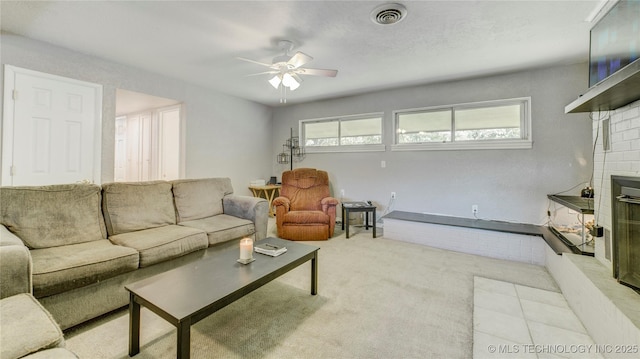 carpeted living room featuring ceiling fan and visible vents