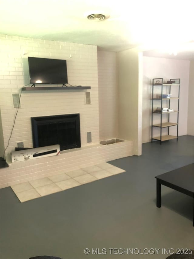 unfurnished living room with a glass covered fireplace and visible vents