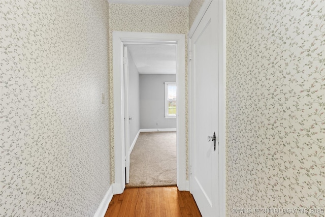 1201 E 18th, Ada, OK 74820 - hallway featuring baseboards, wallpapered walls, and wood finished floors