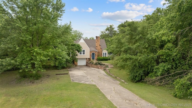 1201 E 18th, Ada, OK 74820 - obstructed view of property with a garage, a front lawn, a chimney, and concrete driveway