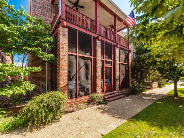 31 Park St, Carlton Landing, OK 74432 - entrance to property featuring a ceiling fan, a balcony, and brick siding
