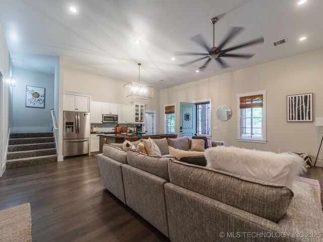31 Park St, Carlton Landing, OK 74432 - living area featuring dark wood-style floors, visible vents, recessed lighting, ceiling fan with notable chandelier, and stairway