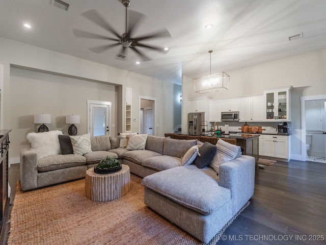 31 Park St, Carlton Landing, OK 74432 - living room with dark wood-type flooring, visible vents, recessed lighting, and ceiling fan with notable chandelier